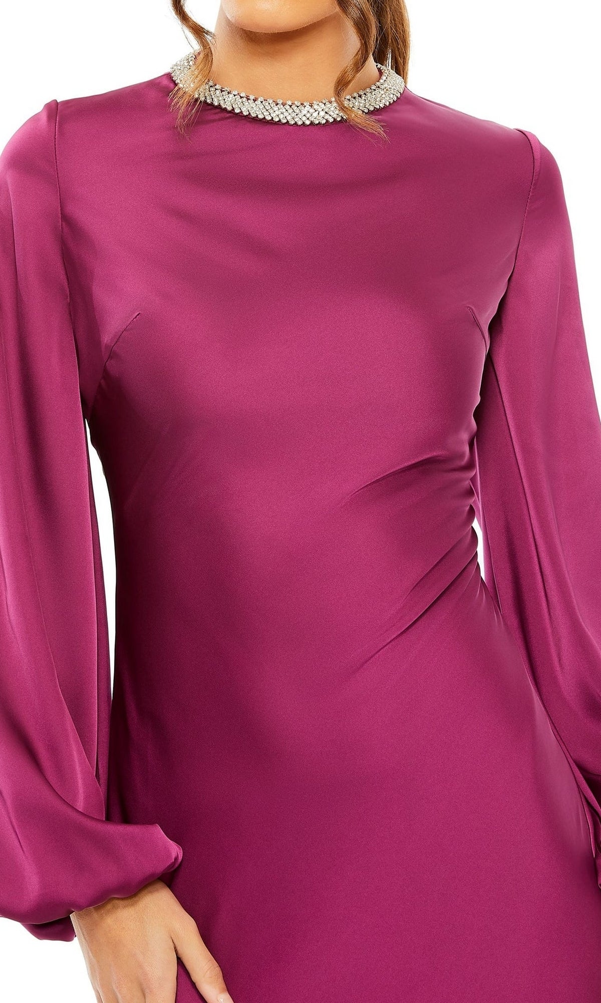 A woman wearing the Mac Duggal 26575, a magenta long sleeve formal dress with a round neckline accented by pearl-like embellishments.